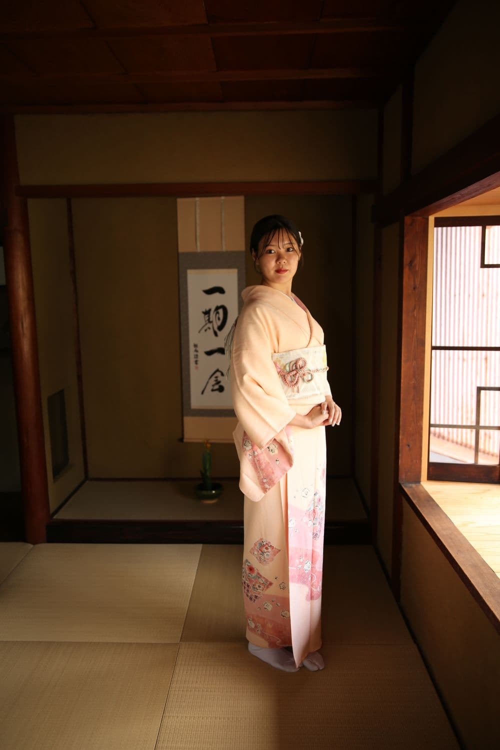 Portraits of guests in kimono beside the hanging scroll
