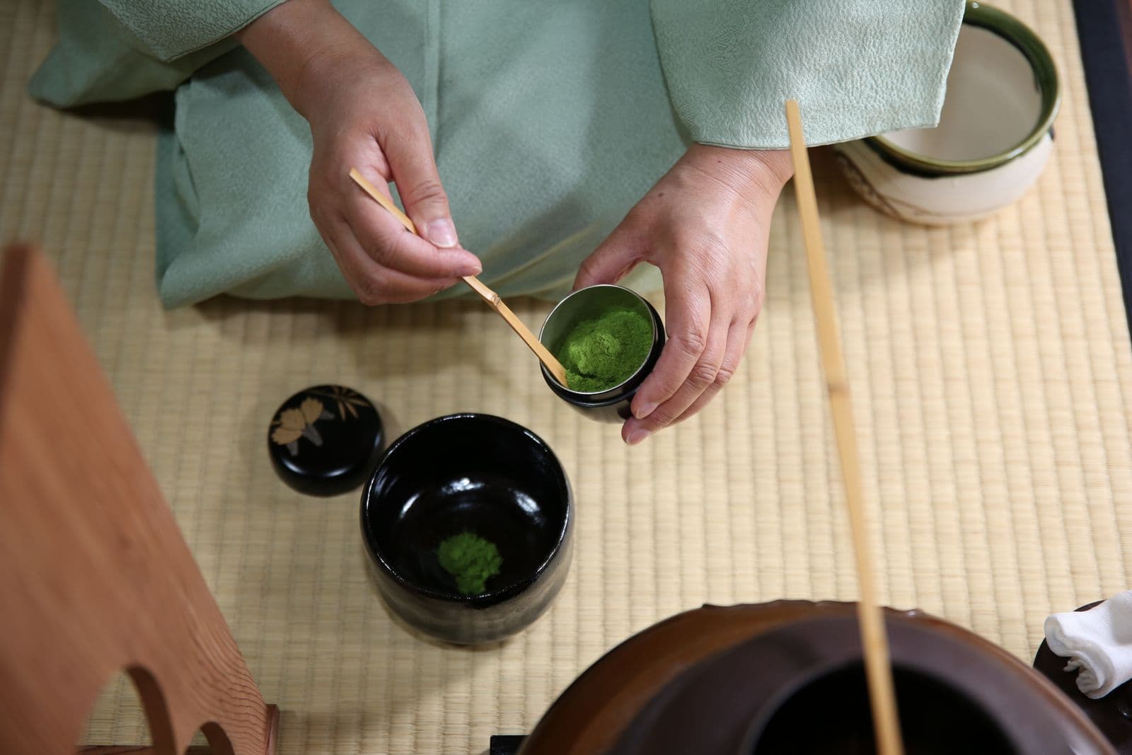 Instructor preparing matcha, overhead view