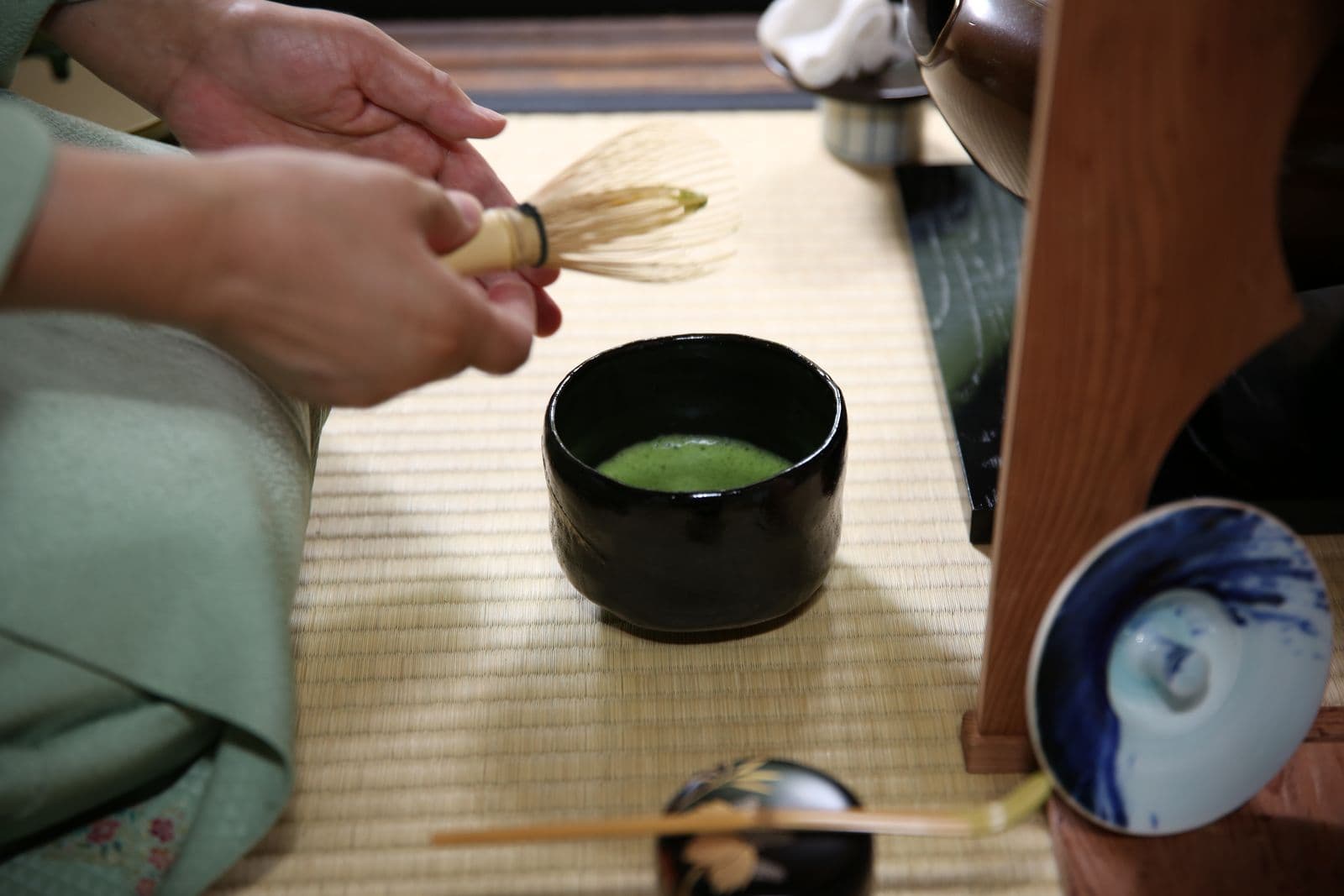 Whisking matcha with a bamboo whisk